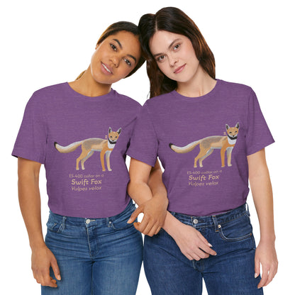Two dark haired women wearing purple t-shirts with a swift fox illustration and text on a white background.