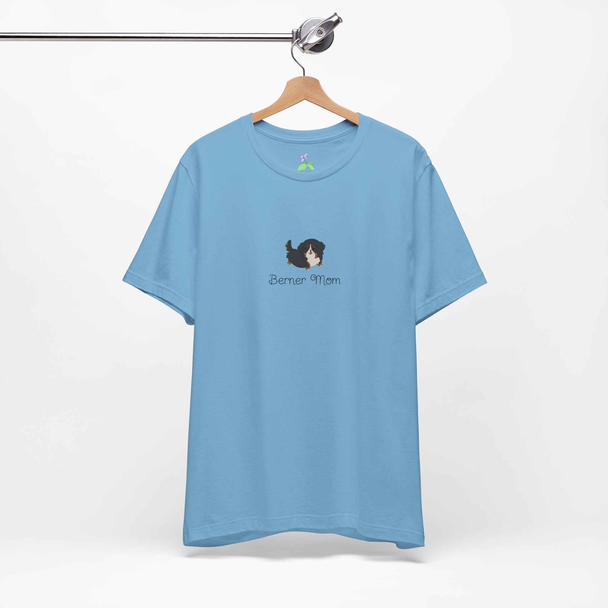 Blue t-shirt with a kawaii dog illustration and 'Berner Mom' text on a hanger against a white background