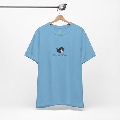 Blue t-shirt with a kawaii dog illustration and 'Berner Mom' text on a hanger against a white background