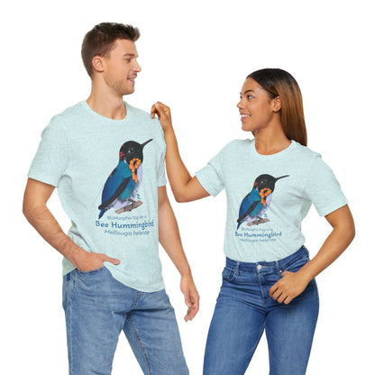 a dark haired man and woman standing together while wearing matching light blue t-shirts with a colorful bee hummingbird illustration and text on a white background
