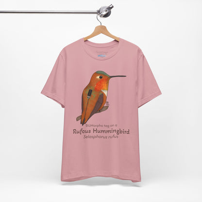 light Pink t-shirt with a Rufous Hummingbird illustration and text on a hanger against a white background