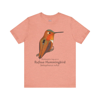 Peach-colored t-shirt with a Rufous Hummingbird illustration and text on a white background