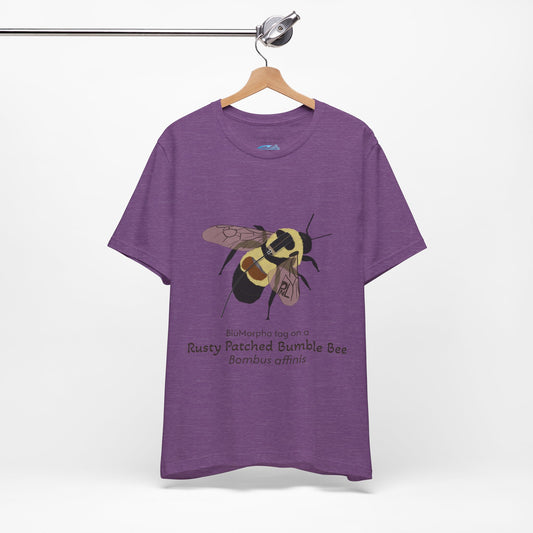 Purple t-shirt with a rusty patched bumble bee illustration and text on a hanger against a white background