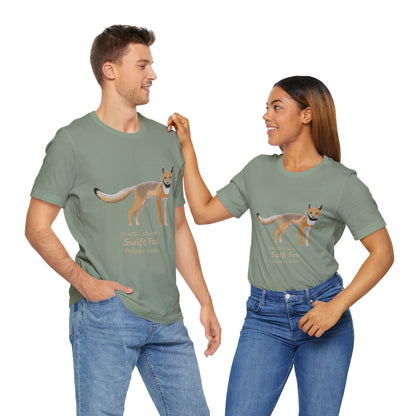 a dark haired man and woman standing together while wearing matching sage green t-shirts with a swift fox illustration and text on a white background