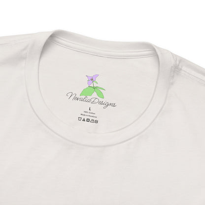White t-shirt inner neck label with a small logo, featuring a purple flower and 'Nevalia Designs' text.