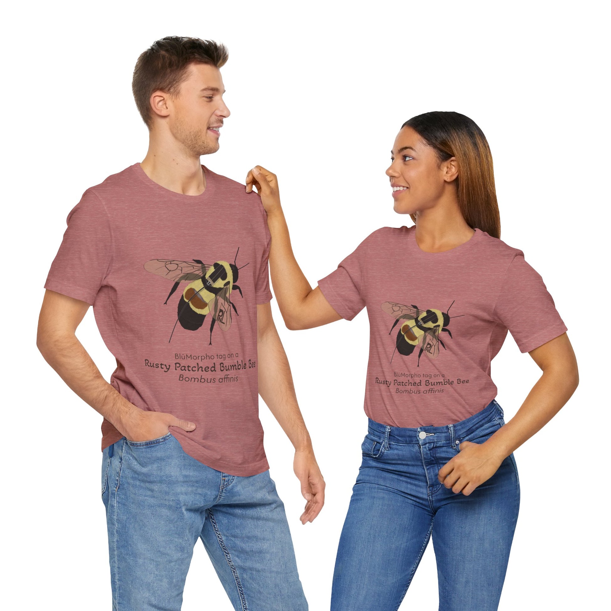 a dark haired man and woman standing together while wearing matching mauve t-shirts with a rusty patched bumble bee illustration and text on a white background