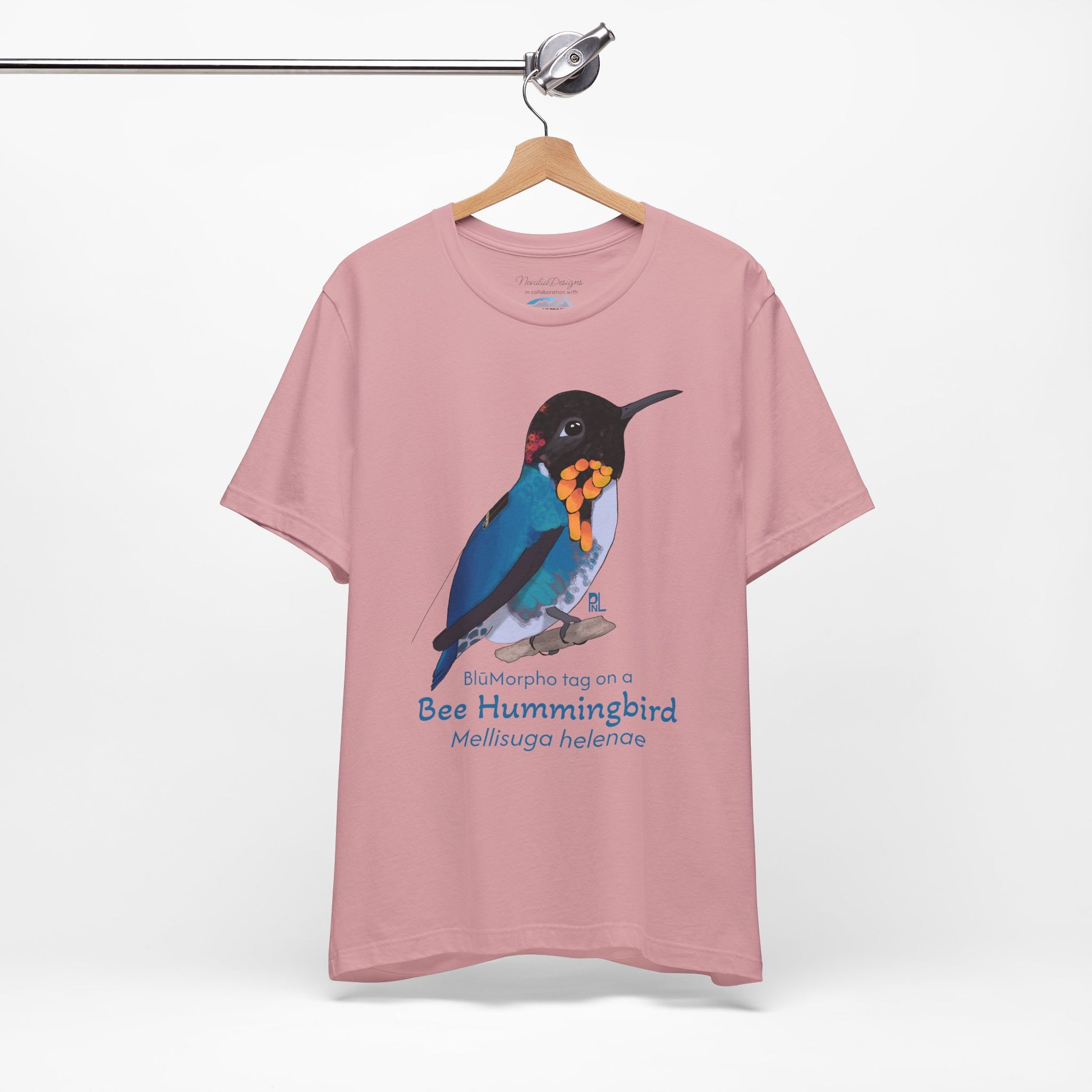 light Pink t-shirt with a colorful bee hummingbird illustration and text on a hanger against a white background