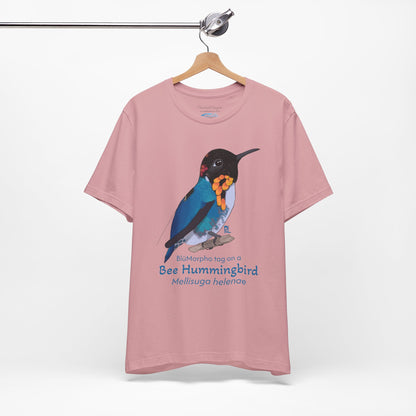 light Pink t-shirt with a colorful bee hummingbird illustration and text on a hanger against a white background