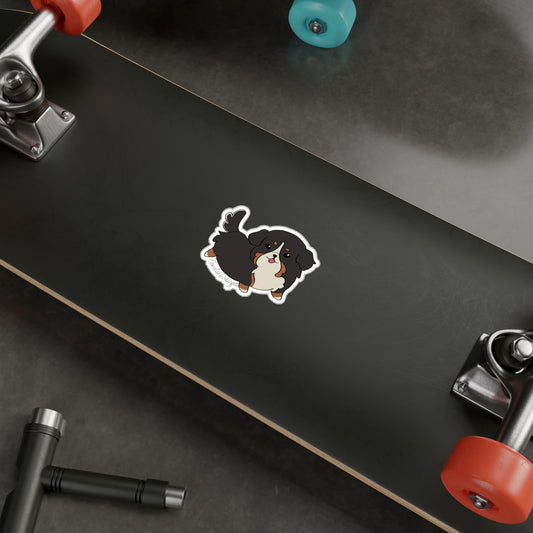 kawaii dog sticker on the underside of a skateboard with red wheels.