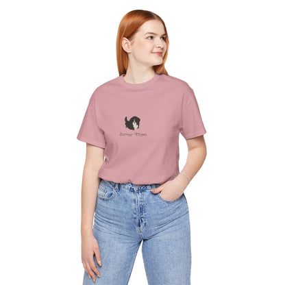 Red haired woman wearing a pink t-shirt with a kawaii dog illustration and 'Berner Mom' text on a white background