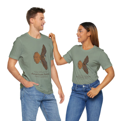 A dark haired man and woman standing while wearing matching sage green t-shirts with an American kestrel illustration and text on a white background