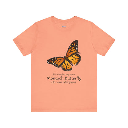 Peach t-shirt with a monarch butterfly illustration and text on a white background